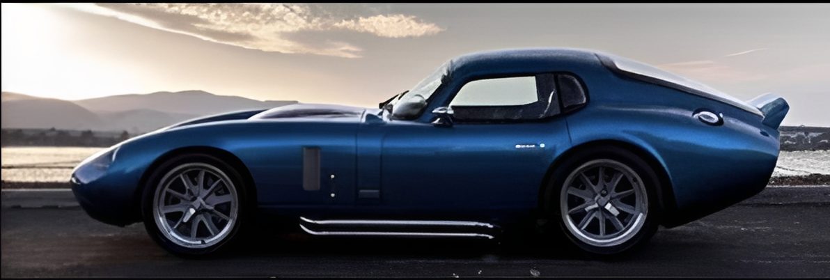 Blue vintage sports car at sunset.