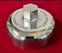 Metal knob with "undo" directions on top.
