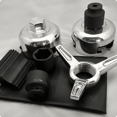 Automotive tools and adapters on a surface.