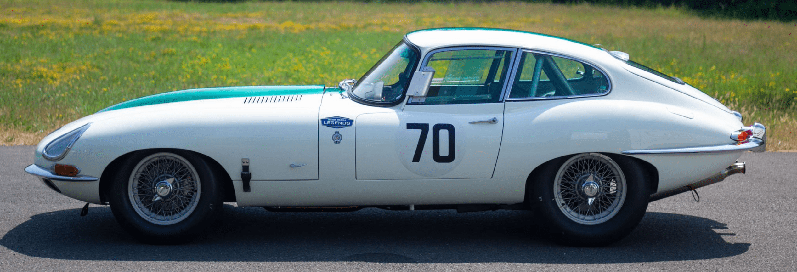 Classic white car with number 70, sideview.