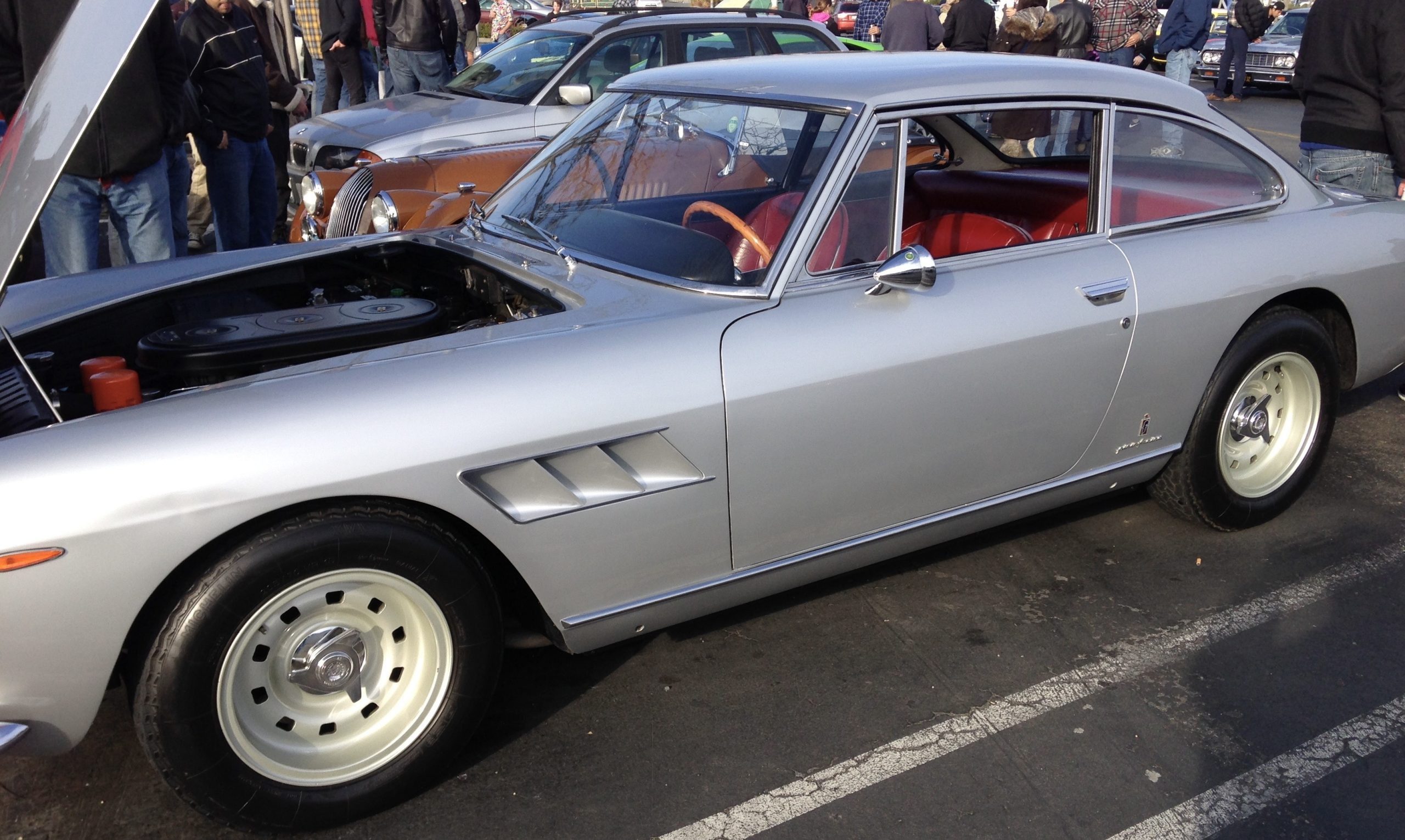 Silver classic car at a car show.