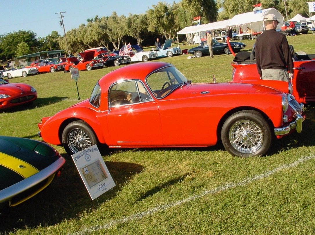 Red vintage car on display at show.