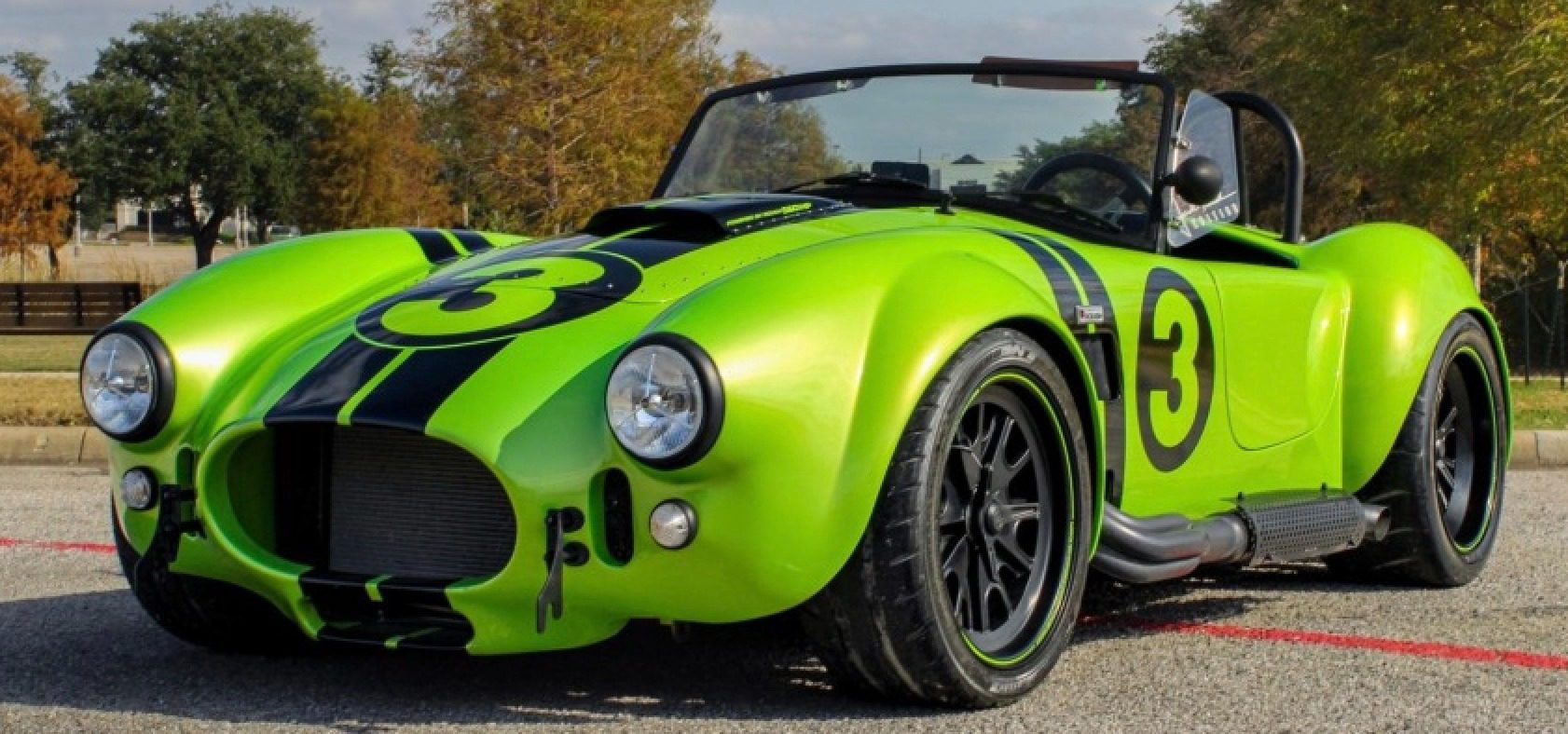 Green vintage race car with black stripes.