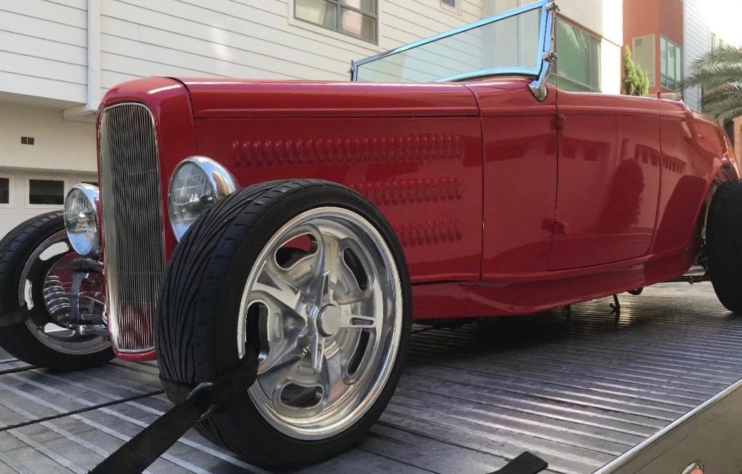 Red vintage convertible car on display.