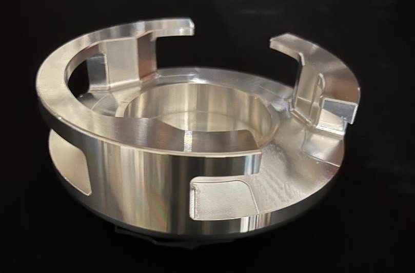 Metallic industrial component with circular design.