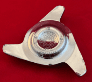 Chrome wheel spinner on red background.
