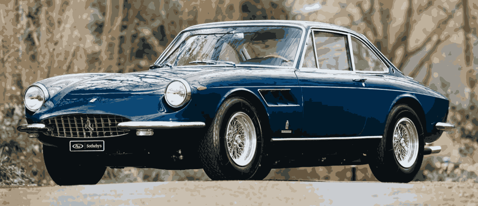 Blue classic vintage car on road.