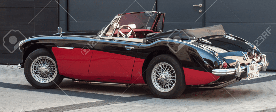 Classic red and black convertible sports car.