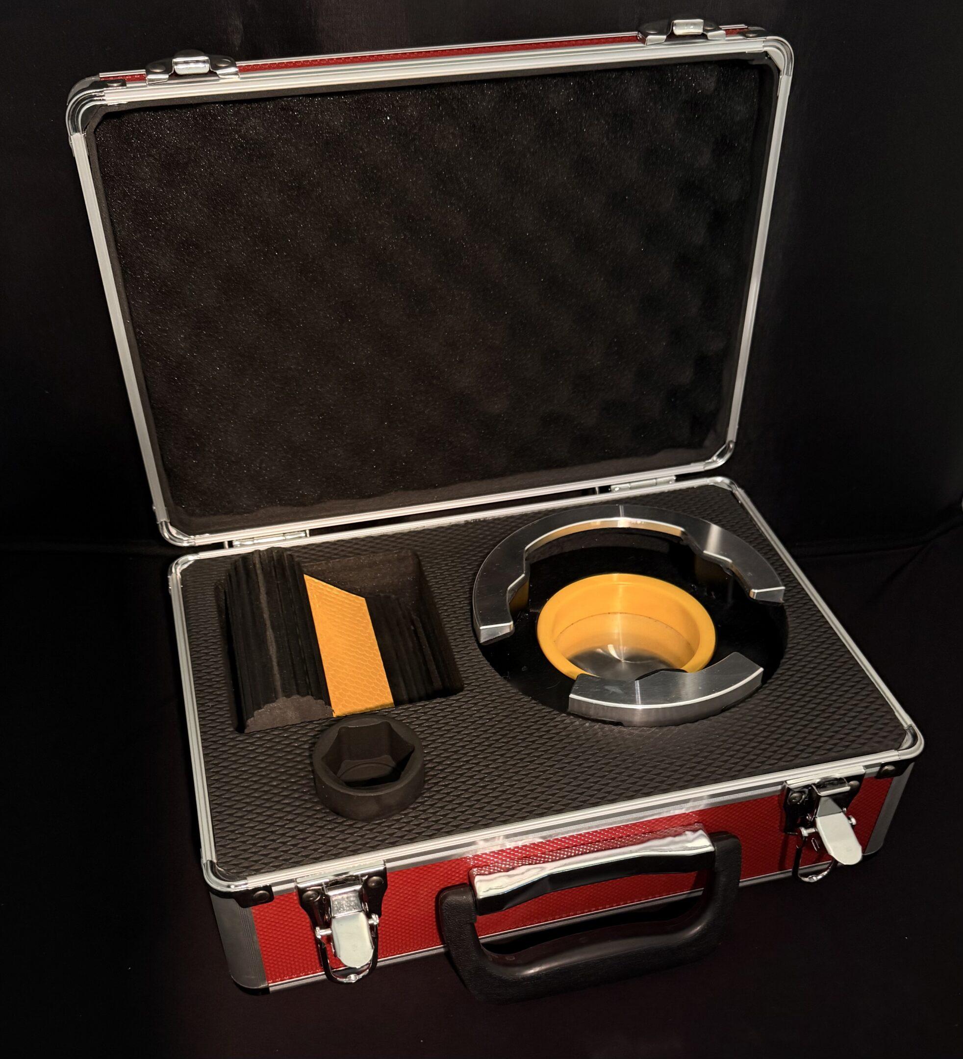 Open red case with yellow circular tool