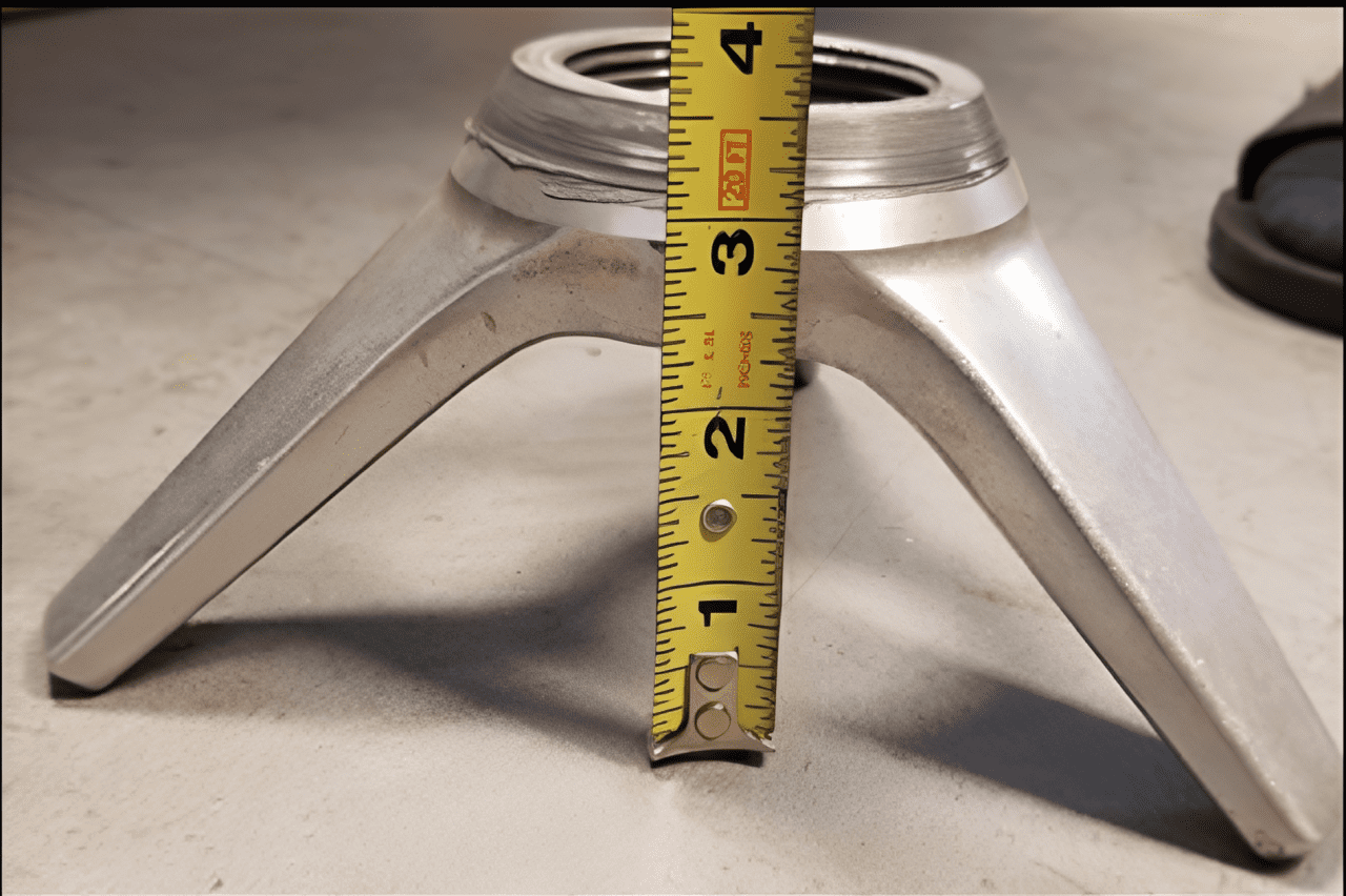 Tape measure against three-legged metal base