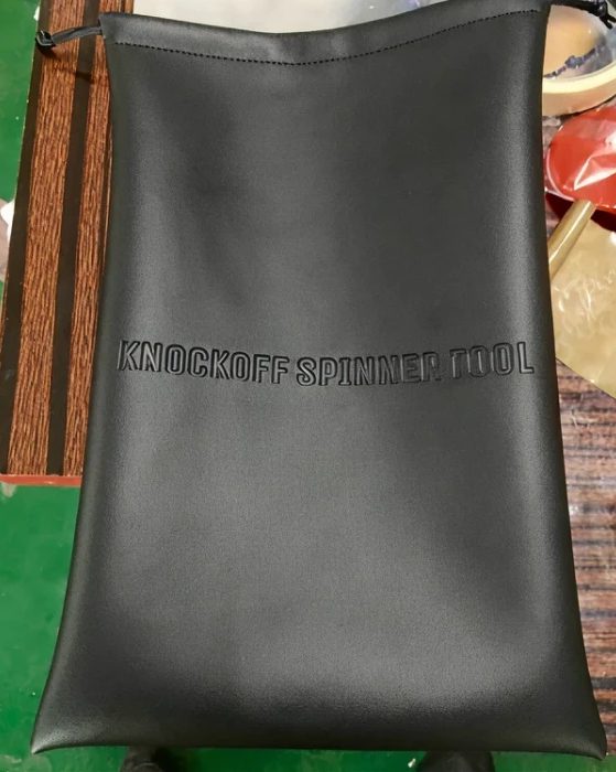 Black pouch embossed "KNOCKOFF SPINNER TOOL