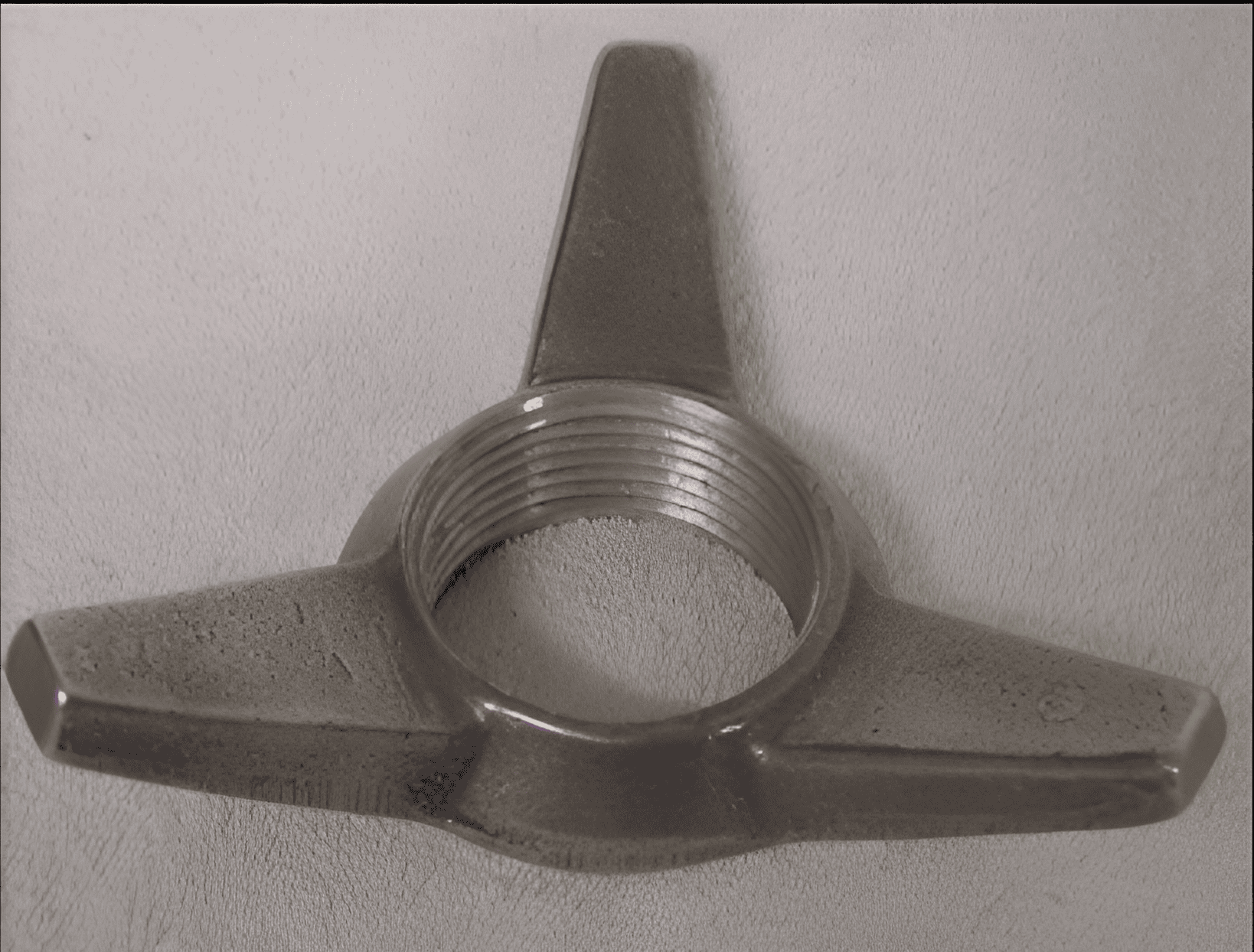 Three-pronged metal threaded nut